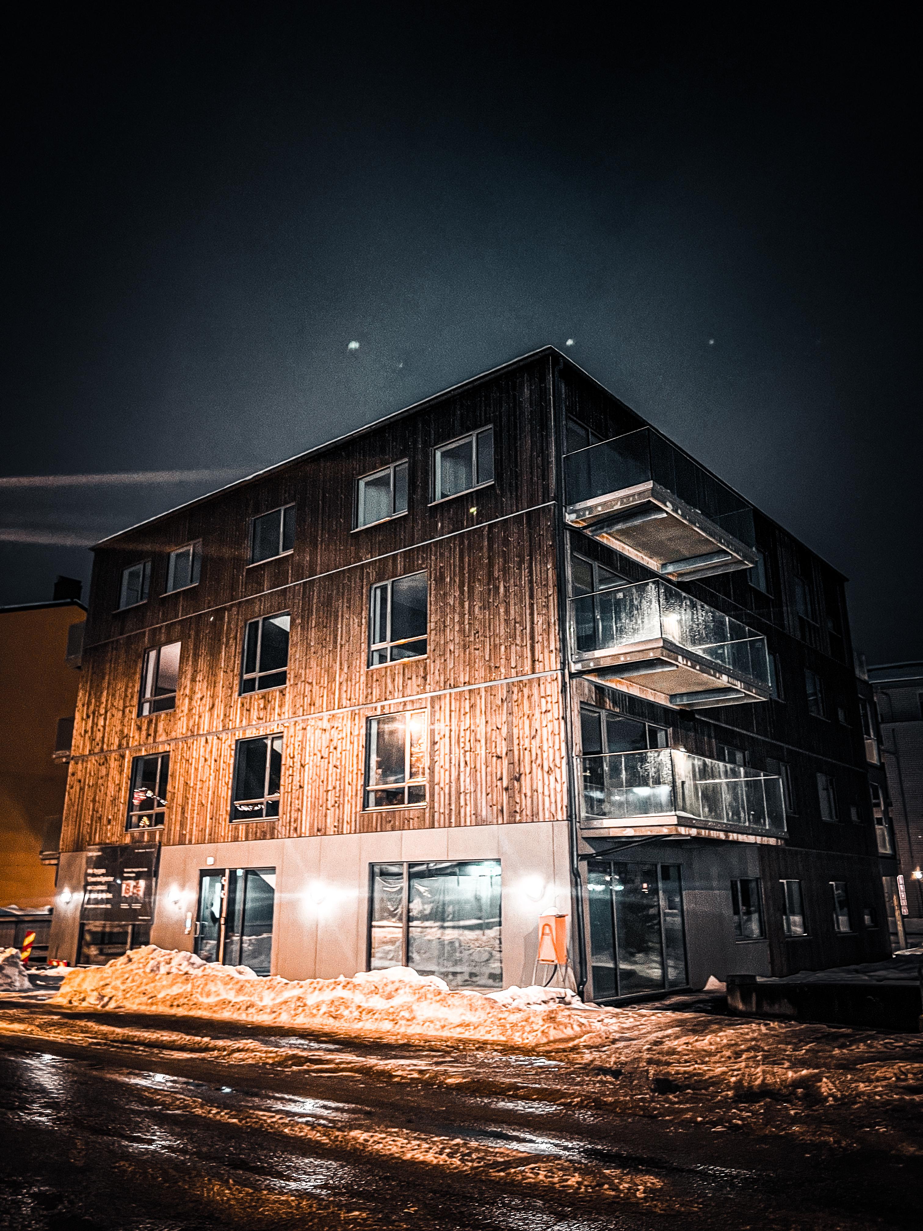 Bygg med trekledning, opplyst om kvelden